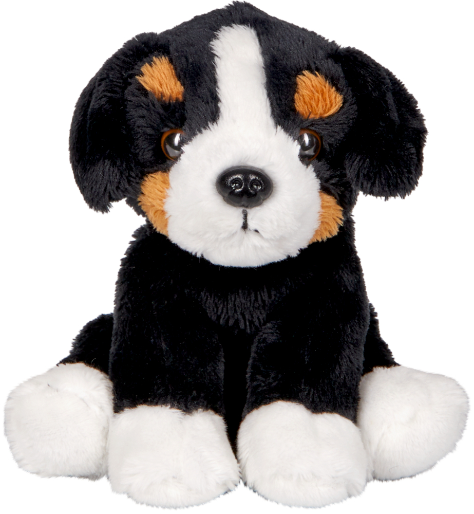Plüschiges Hundespielzeug in Schwarz, Weiß und Braun sitzt aufrecht und blickt nach vorne.