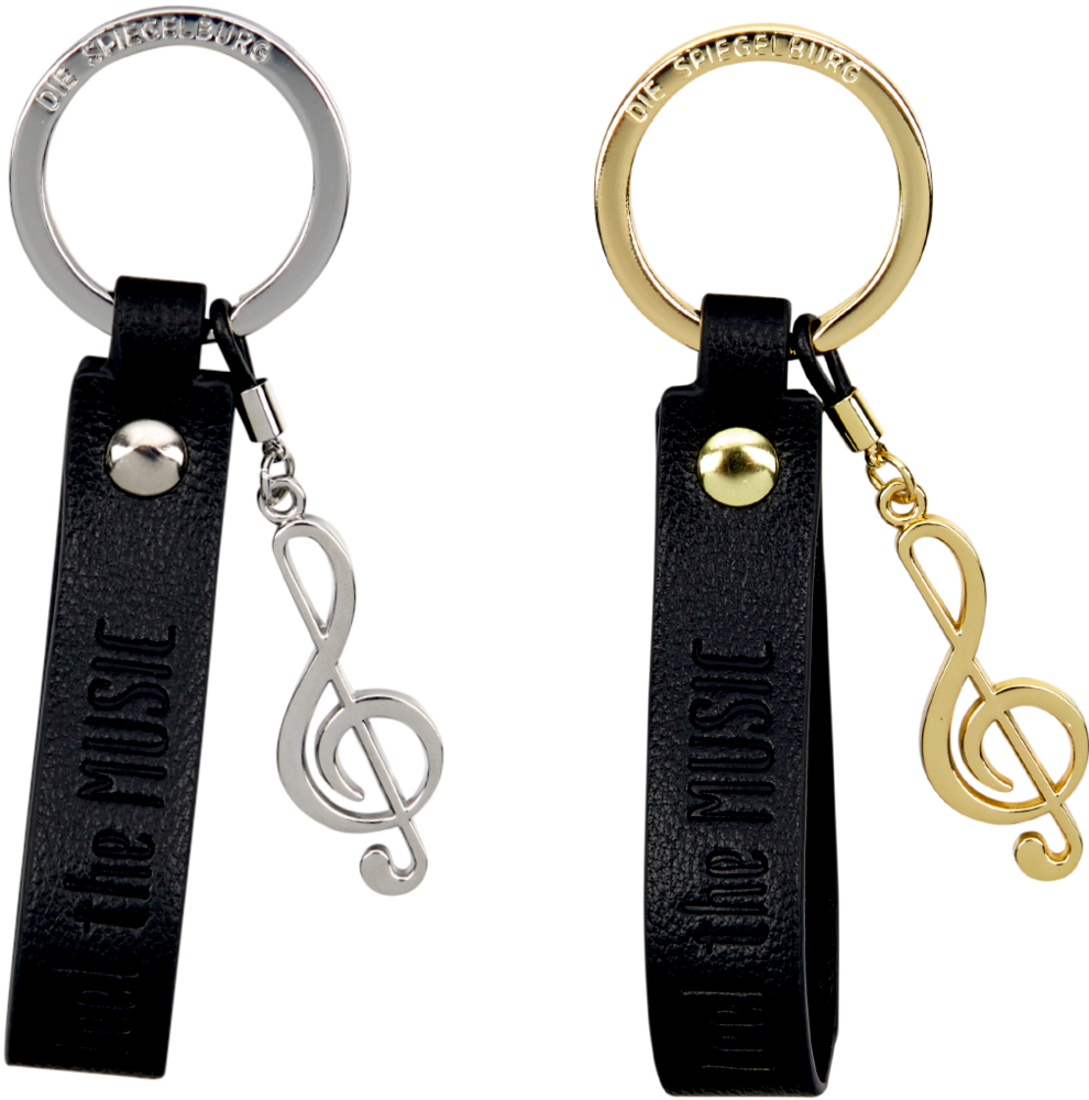 Zwei Schlüsselanhänger mit Violinschlüsseln, einer silber, einer gold, an schwarzen Bändern mit Aufdruck FEEL THE MUSIC.