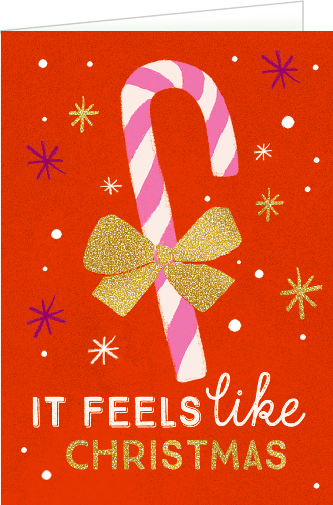 Rote Karte mit weiß-rosa Zuckerstange, goldener Schleife, Sternen und dem Text „It feels like Christmas“.