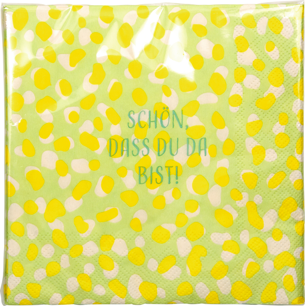 Grüne Serviette mit gelben und weißen Punkten. In der Mitte steht: Schön, dass du da bist!.