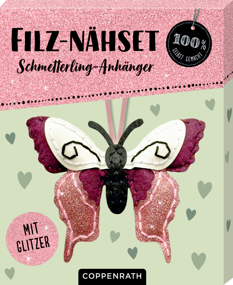 Nähset-Box aus rosa und weißem Filz in Schmetterlingsform mit Glitzerakzenten im Hintergrund.