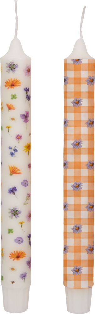 Zwei große weiße Kerzen: eine mit Blumenmuster, die andere mit einem orangefarbenen Karo- und Blumenmuster.