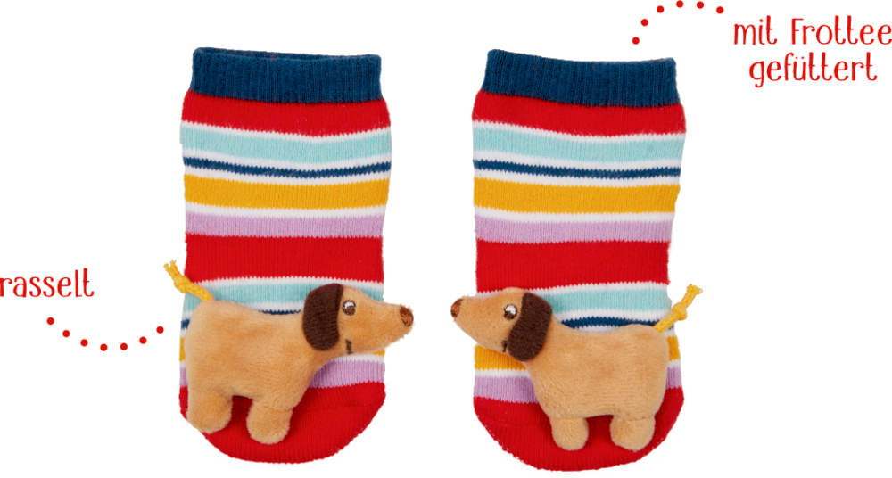 Bunt gestreifte Socken mit plüschigen, hellbraunen Hunden auf den  Zehen, wobei die Hunde einander zugewandt sind. Daneben der Text "mit Frottee gefüttert" und "rasselt".