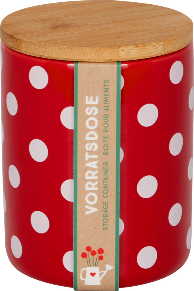 Rotes, rundes Keramikglas mit weißen Punkten und Holzdeckel, verpackt mit einer braunen Papierbanderole.
