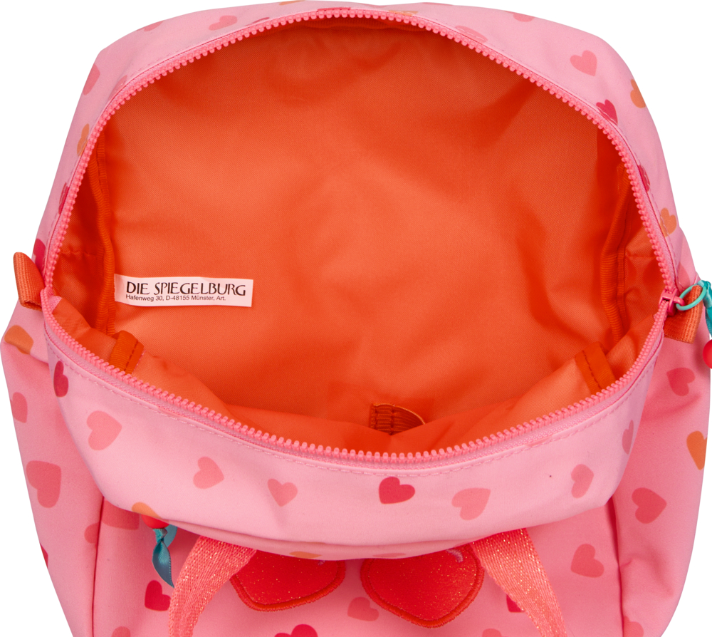 Offener pinker Rucksack mit rotem Herzmuster, orangefarbenem Innenfutter, sichtbarem Etikett.