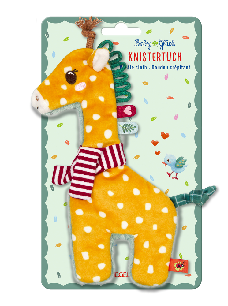 Plüsch Giraffe gelb mit weißen Punkten und gestreiftem Schal vor bunter Verpackung mit spielerischen Mustern.