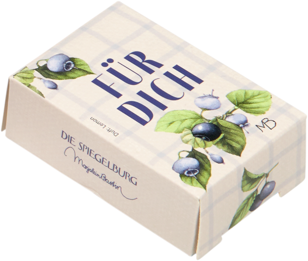 Eine kleine cremefarbene Box mit der Aufschrift FÜR DICH und Blaubeer-Illustrationen auf dem Deckel.