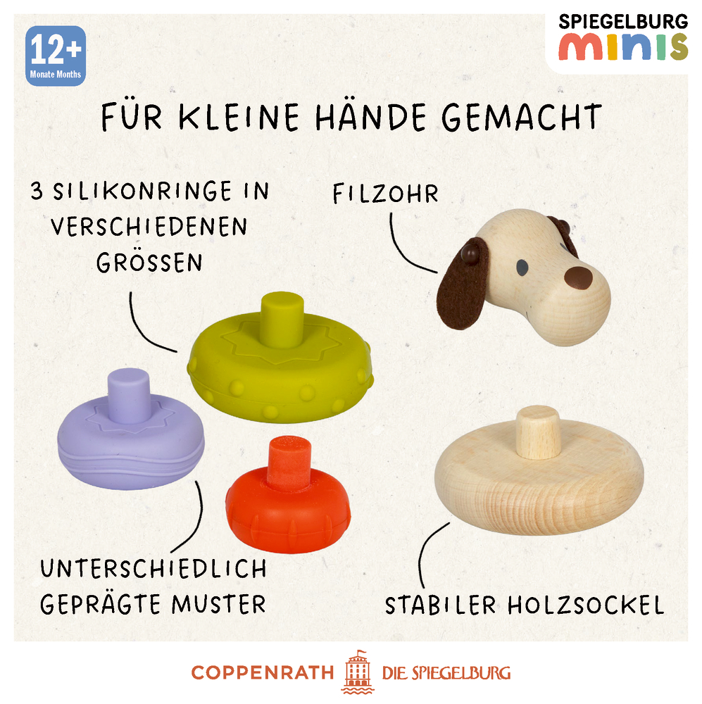 Hund-förmiges Holzspielzeug mit mehreren Silikonringen in verschiedenen Farben und Texturen.