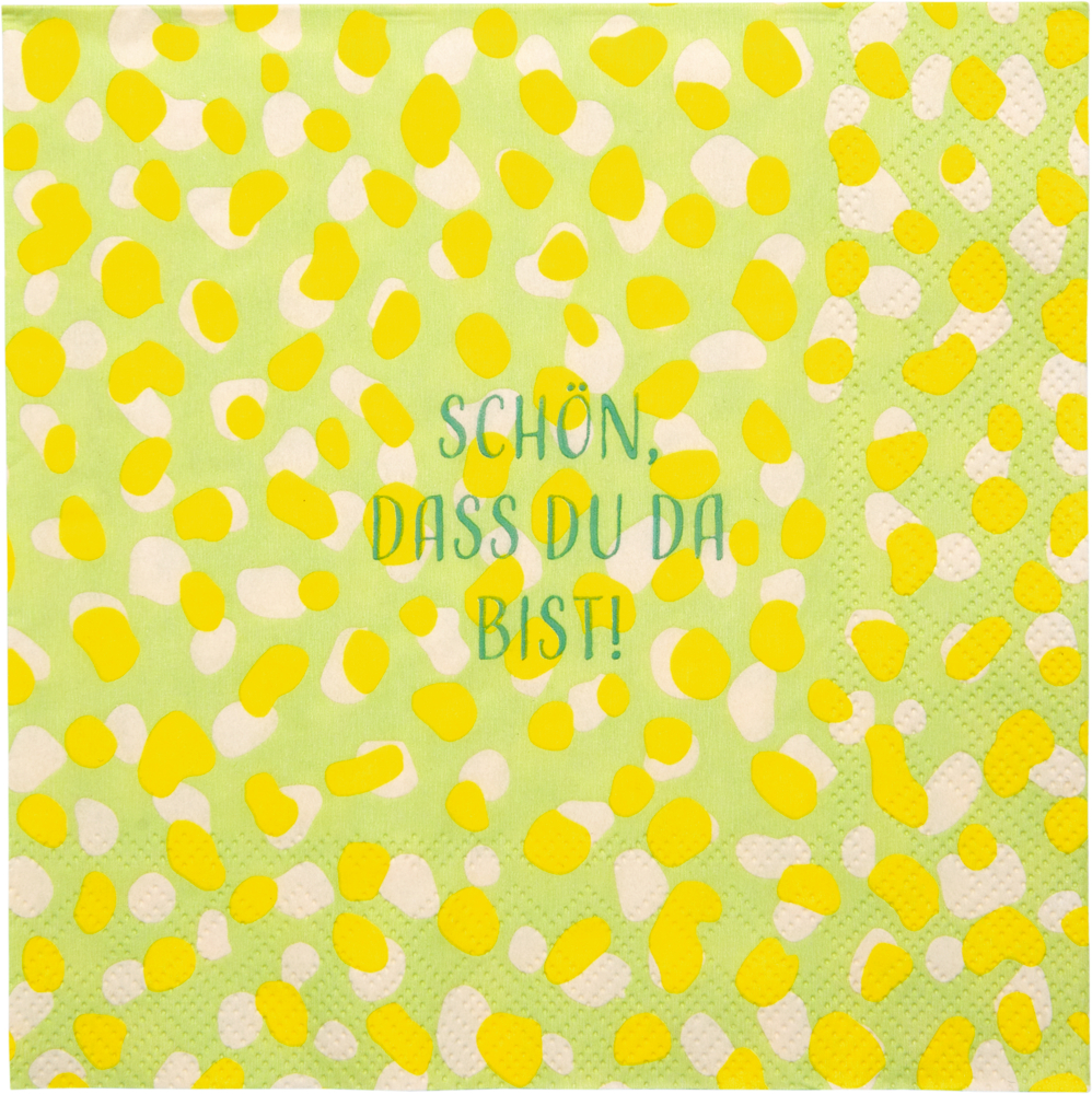 Gelbe Punkte auf grünem Serviettenpapier. Aufschrift: Schön, dass du da bist! in blauen Buchstaben.
