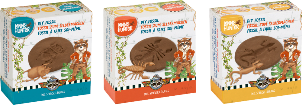 Fossil zum Selbermachen - Lenny Hunter "Drei kleine, farbenfrohe Pappschachteln mit Lenny Hunter Waschbär und verschiedenen fossilen Tieren."