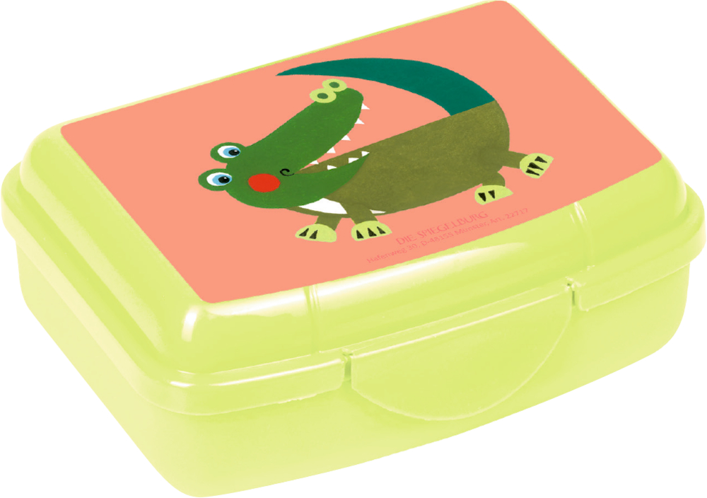 Kleine hellgrüne Lunchbox mit Cartoon-Krokodil auf dem Deckel, vor einem pfirsichfarbenen Hintergrund.