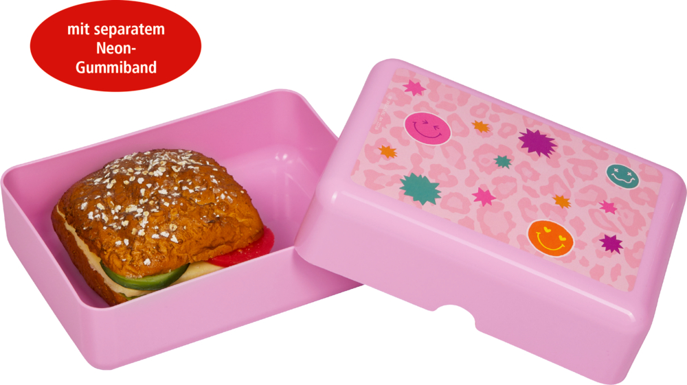 Rosa Lunchbox mit einem lächelnden Gesicht auf dem Deckel und einem Sandwich darin.