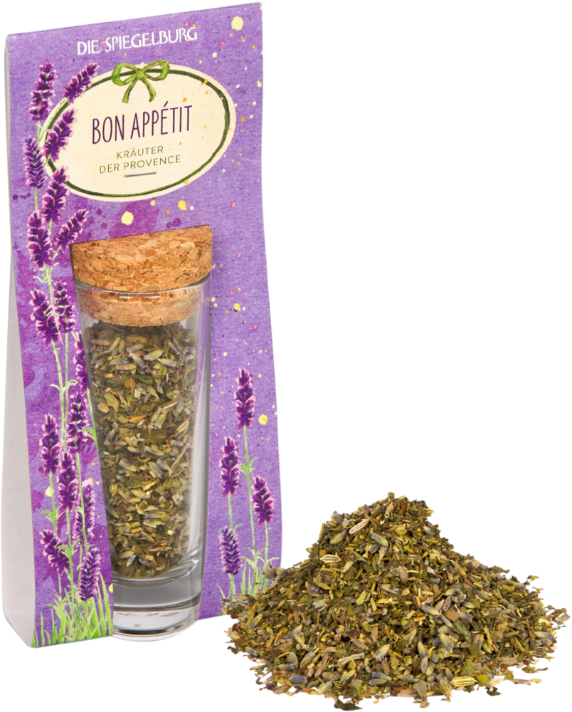 Ein Glasfläschchen mit Korken, lila Verpackung, getrocknete Kräuter davor.