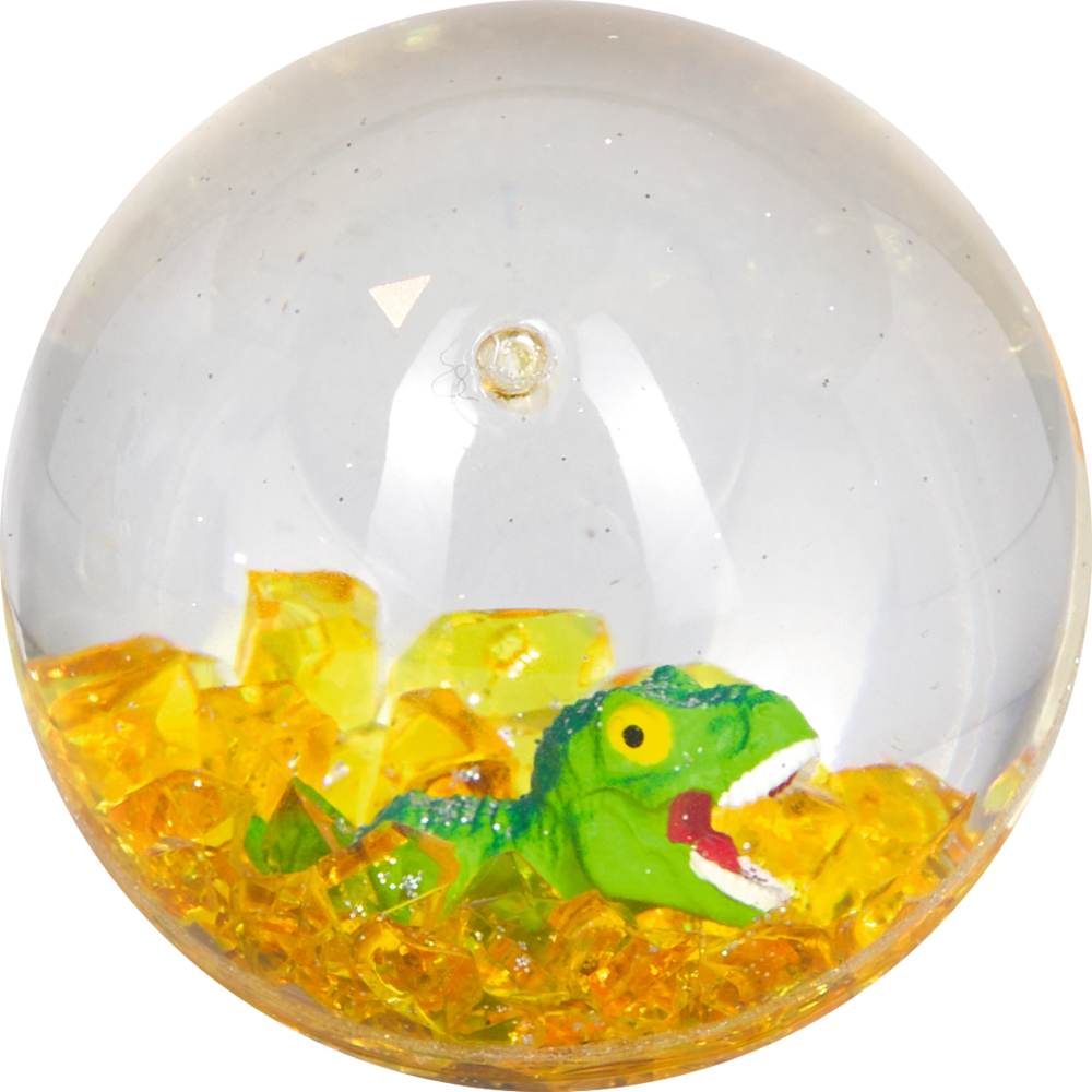 Kunststoffkugel mit kleinem grünen Dinosaurier und gelben Kristallen im Inneren.