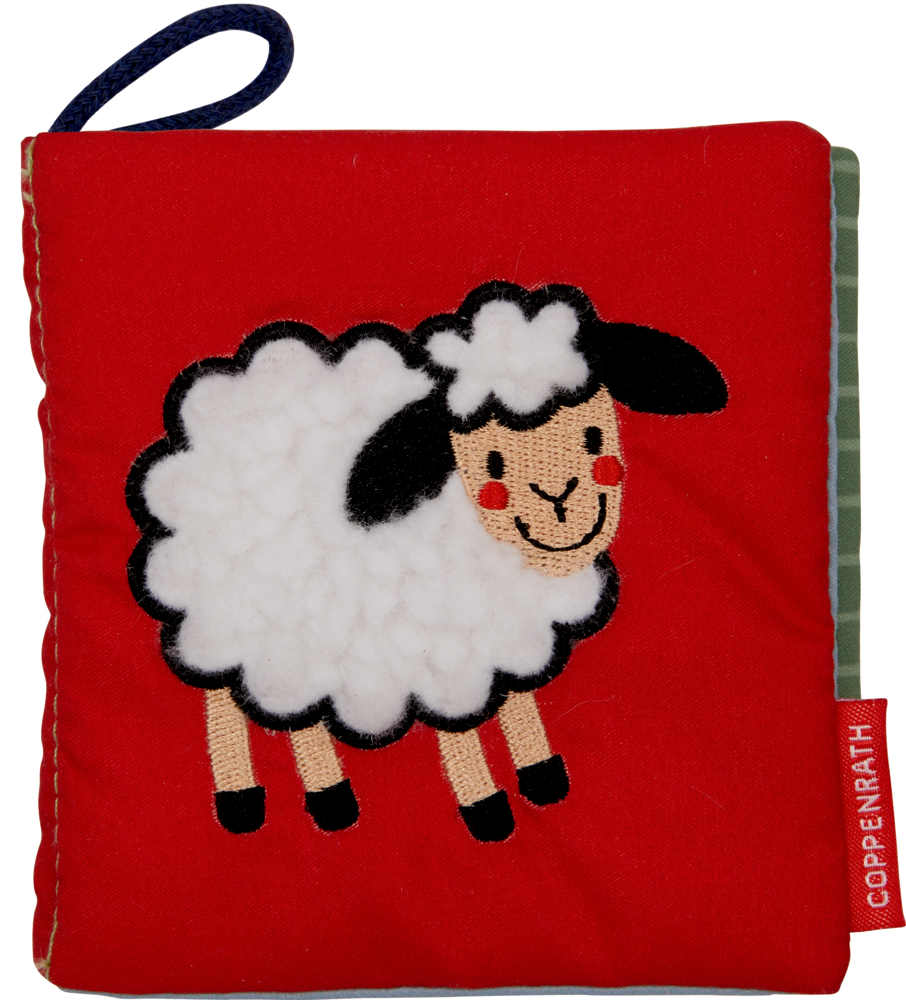 Rotes Stoffbuch mit einem lächelnden weiß-schwarzen Schaf auf dem Einband, abgerundet durch eine blaue Stoffschlaufe.