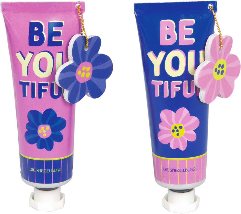 Zwei bunte Tuben mit BE YOU TIFUL Text und Blumenanhängern, eine blau, eine rosa.