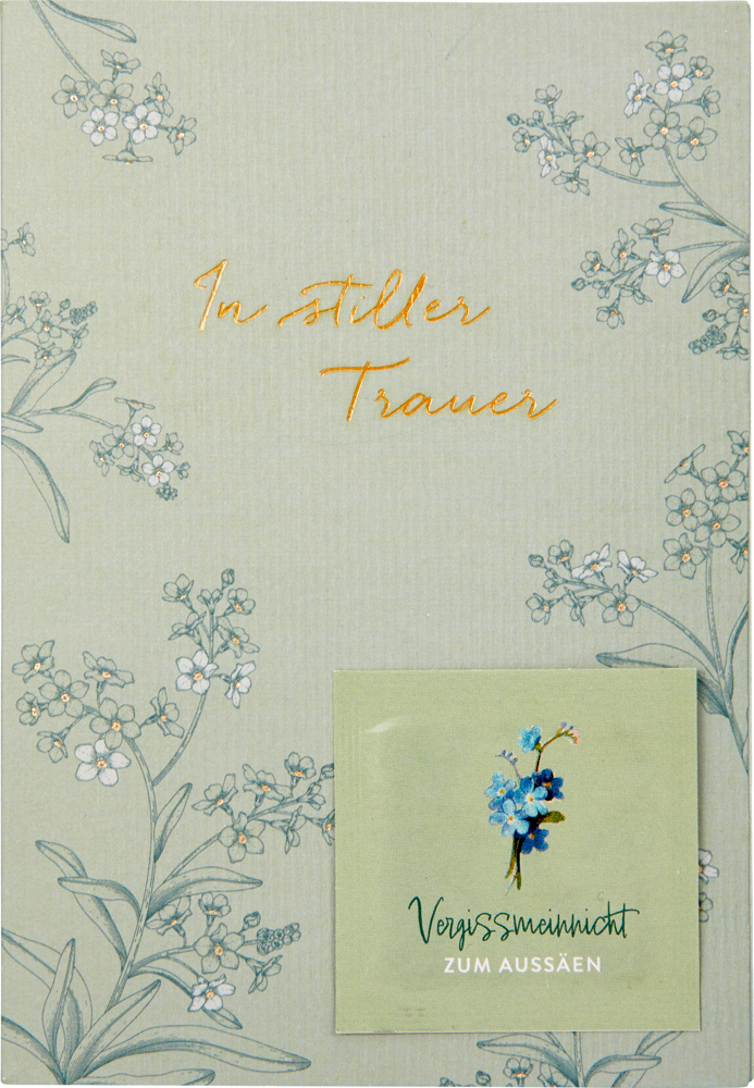Hellgrüne Trauerkarte mit Blumenskizzen, goldenem Text „In stiller Trauer“ und einem beigefügten Samenpaket.
