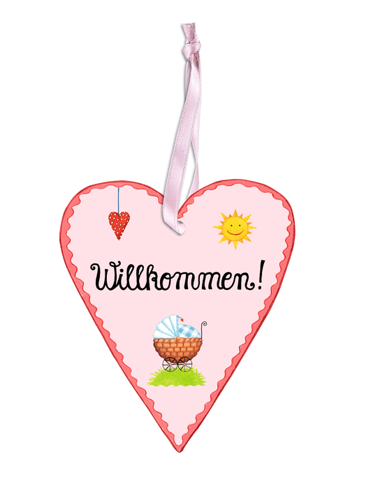 Dekoriertes rosa Herz mit liebevoll geschriebener Aufschift "Willkommen" - befestigt an einem rosa Schleifenband.