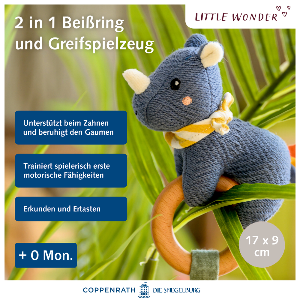 Plüschige blaue Nashorn-Beißrassel auf Pflanze, mit Produktinformation und „+0 Monate“-Etikett.