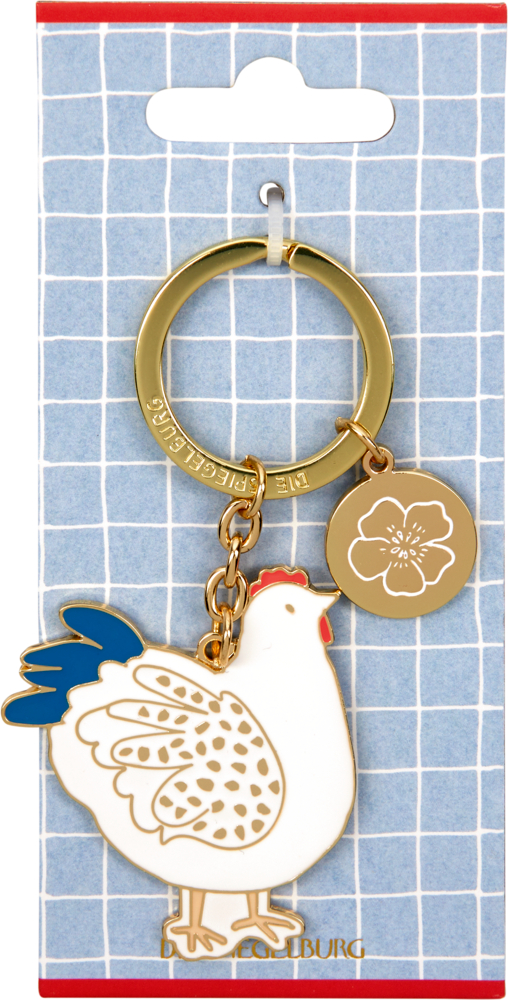 Goldener Schlüsselanhänger mit weißem Huhn und kleinem goldenen Blumenanhänger auf blauer Pappkarte.