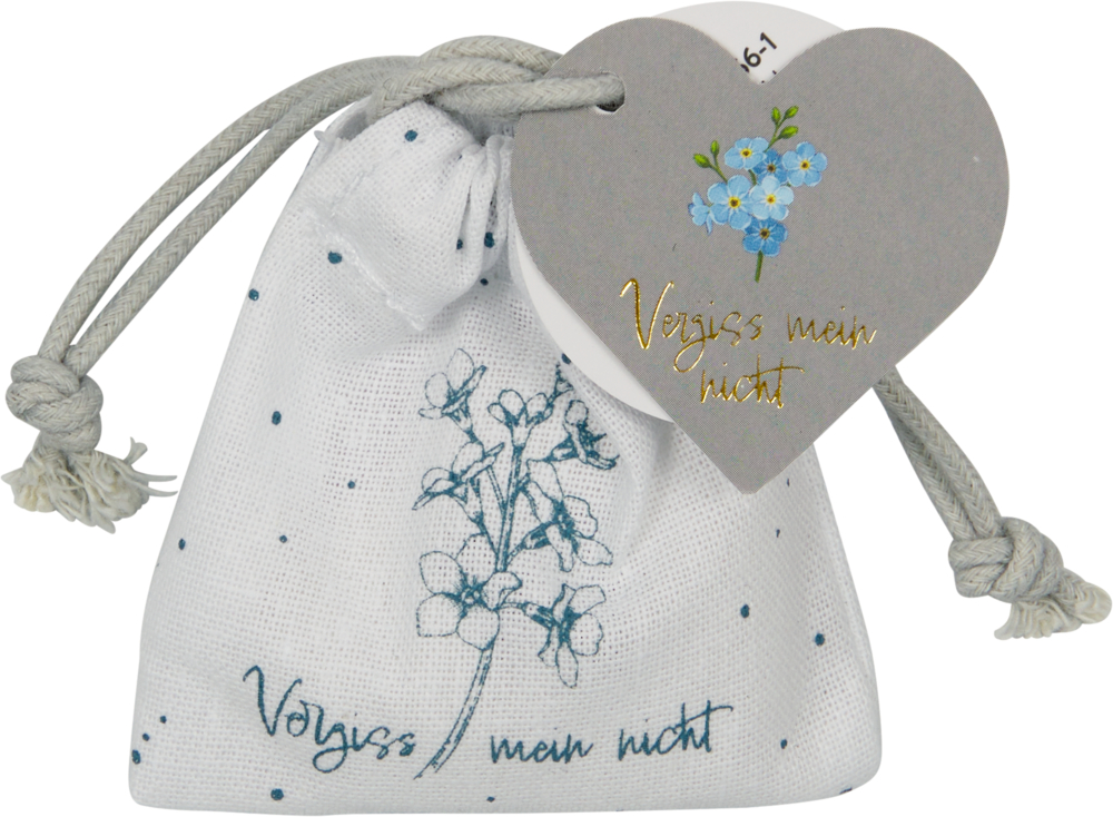 Kleiner weißer Beutel mit Kordelzug, blauem Blumenmuster und herzförmigem Anhänger mit der Aufschrift Vergiss mein nicht.