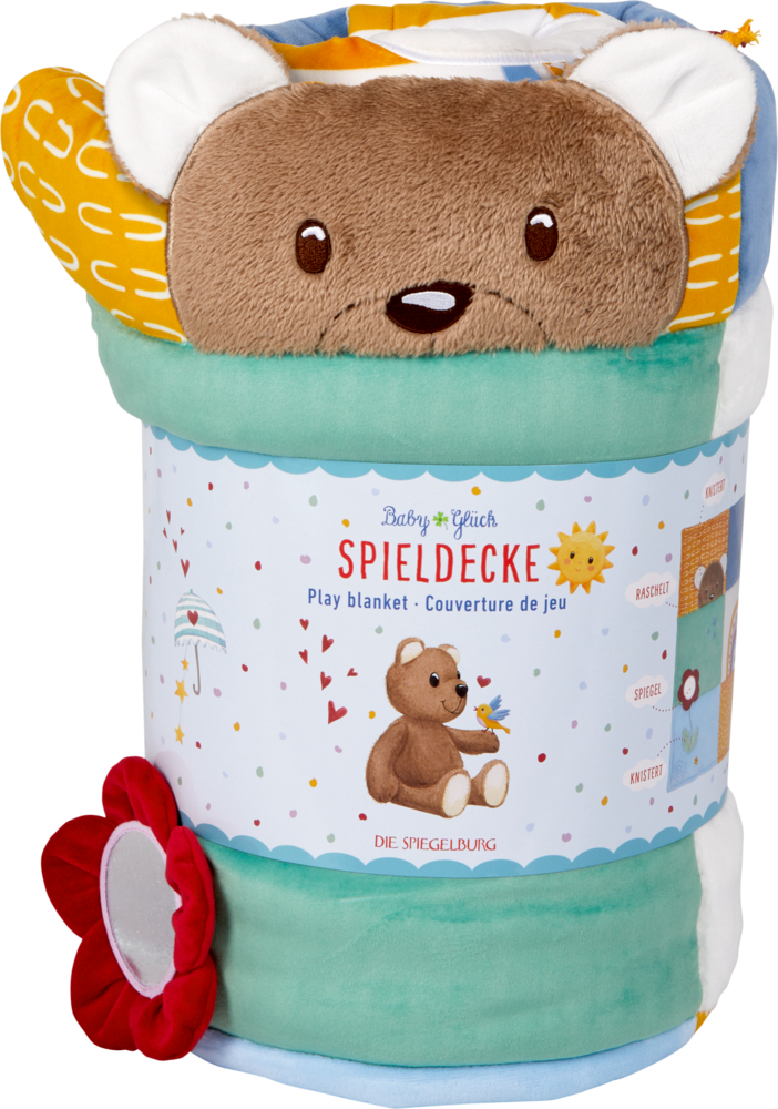Aufgerollte Babyspieldecke mit süßem Bärengesicht, bunten Motiven, roter Blume und dekorativem Etikett.