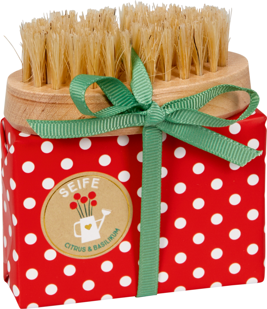 Handpflegeset - Fröhliche Tupfen Rotes Päckchen mit weißen Punkten, grüner Schleife und oben festgebundener Bürste.