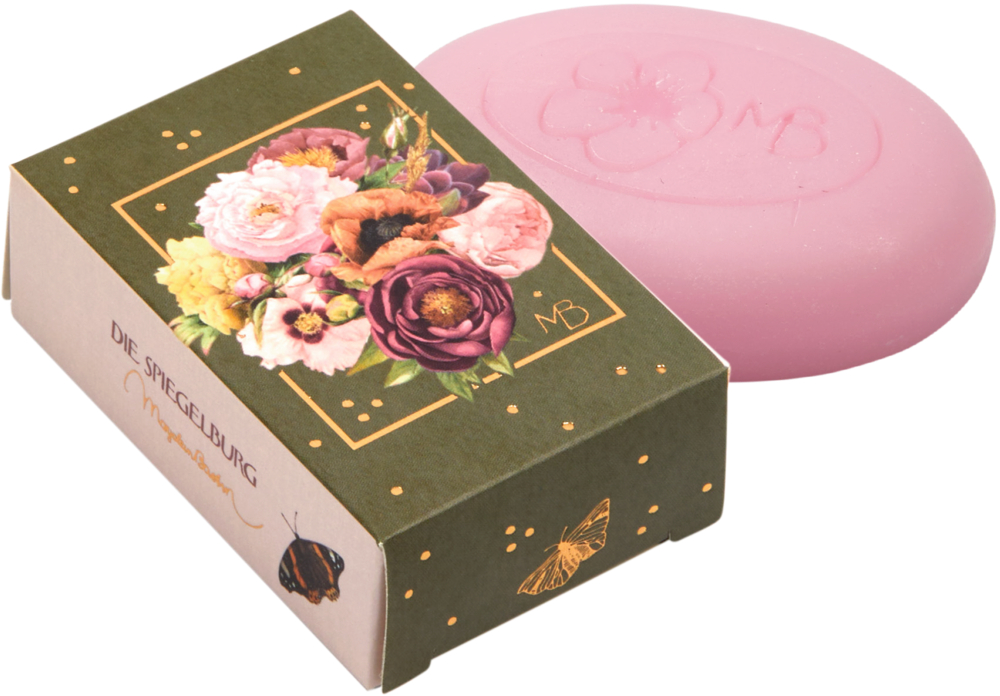 Rosa Seifenstück in einer Blumenschachtel mit goldenen Akzenten und Schmetterlingsillustrationen.