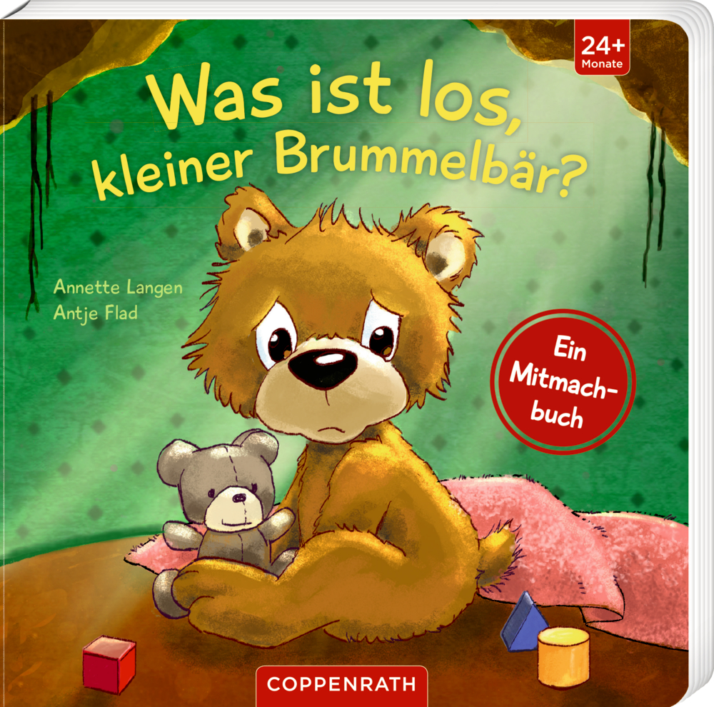 Was ist los, kleiner Brummelbär? Auf dem Cover von "Was ist los kleiner Brummbär?" ist ein trauriger Bär der einen einen Teddy umarmt, während er mit Spielzeug auf dem Boden sitzt, abgebildet.