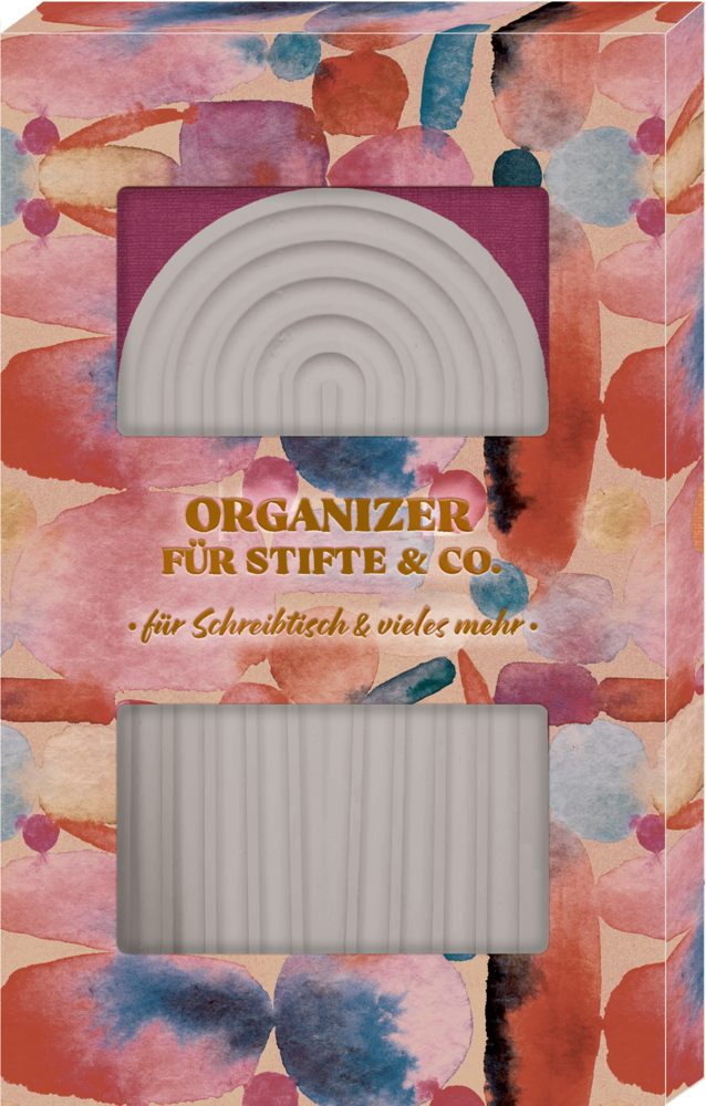 Bunte Box mit goldener Aufschrift, zeigt weißen Schreibtisch-Organizer in Form eines Regenbogens.